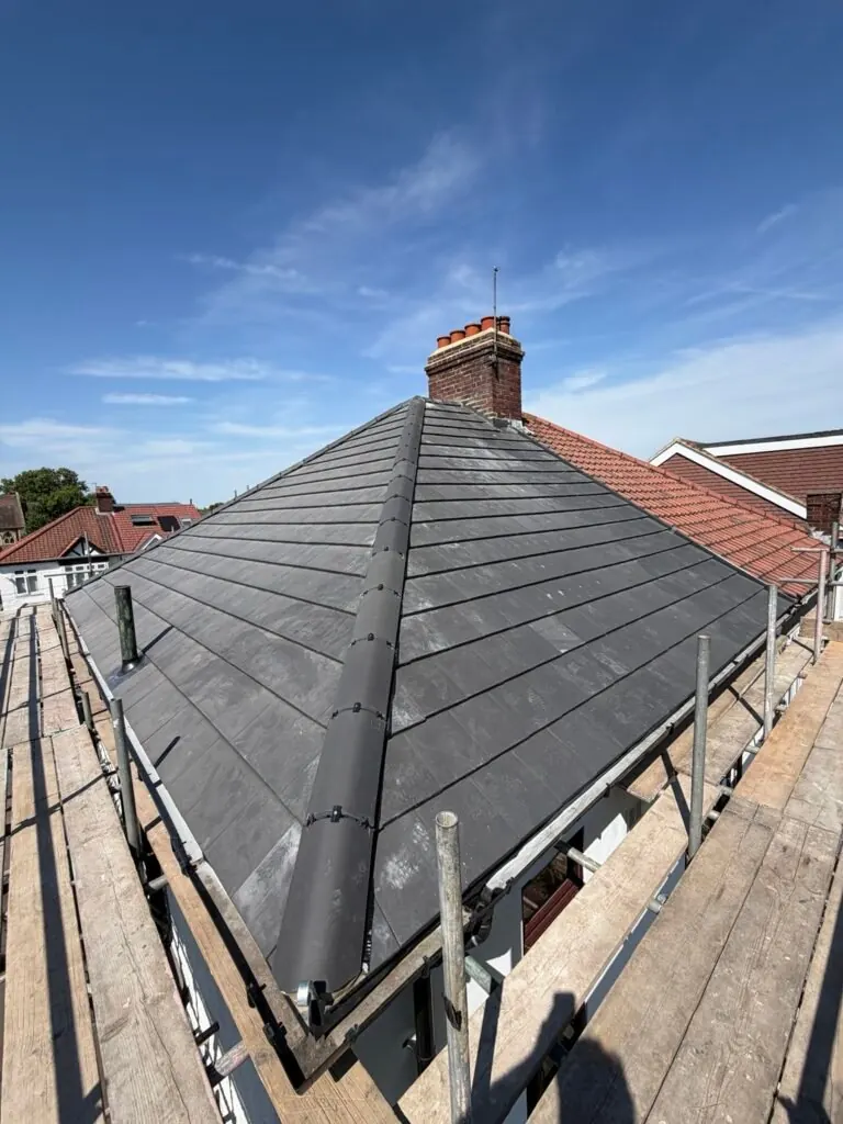 Avent tiled pitched roof with hip tiles, chimney and scaffold access