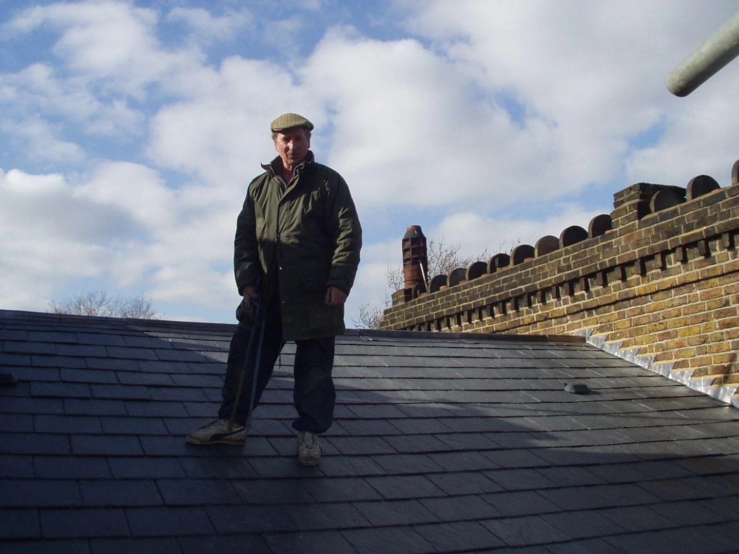 Our grandfather standing on a roof during his roofing career